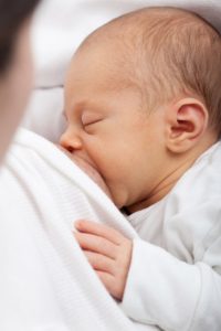 breastfeeding baby with mother