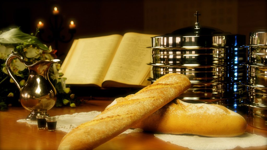 holy supper bread wine on desk with open book