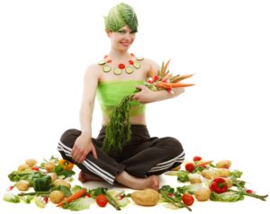 woman wearing clothes made of vegetables holding carrots asparagus and radishes surrounded by vegetables. meal plan information