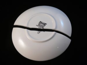 back of a white cracked dinner plate