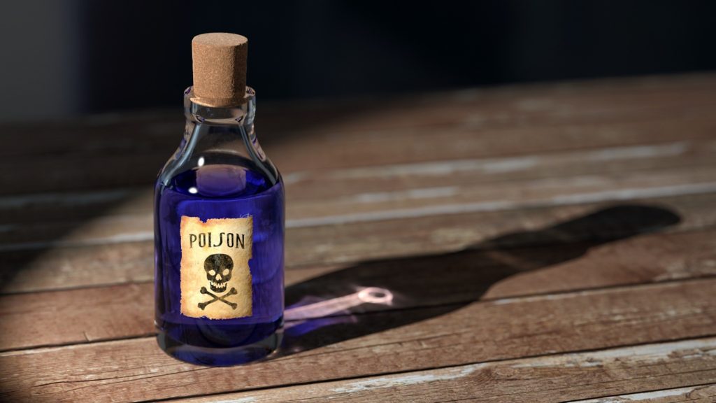 blue liquid in clear glass bottle with cork labeled poison with skull and cross bones on brown wooden table rice contains arsenic