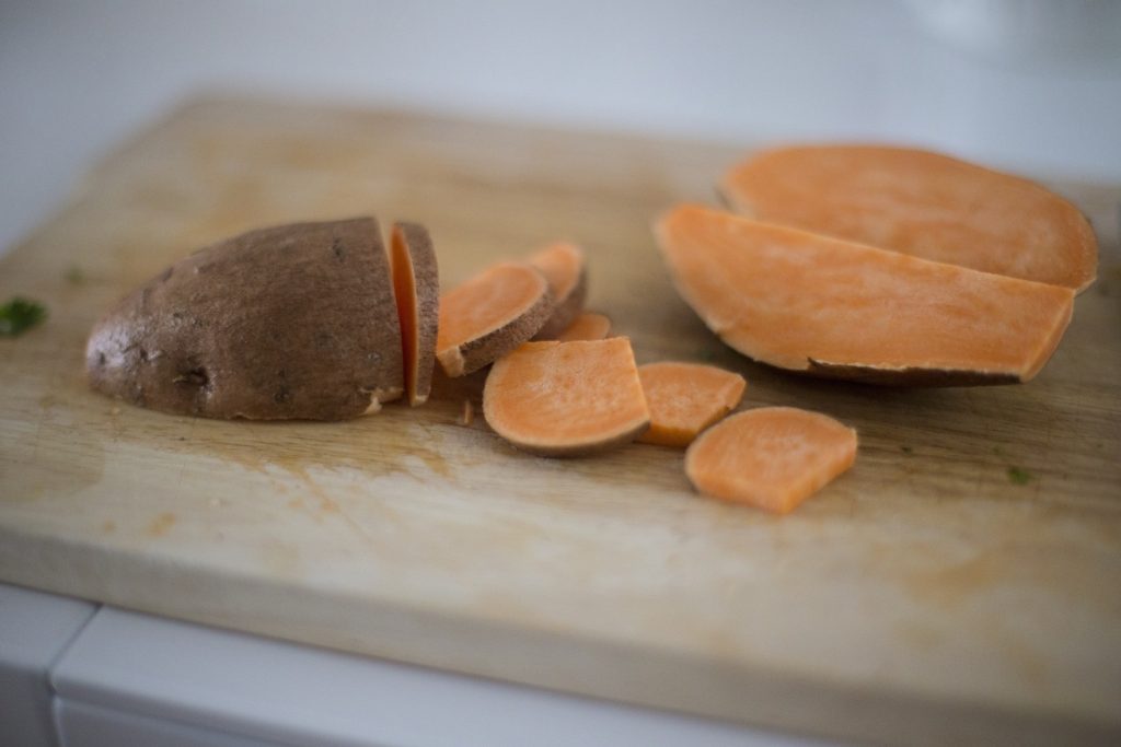 sweet potato sliced on wooden cutting board dietary myths